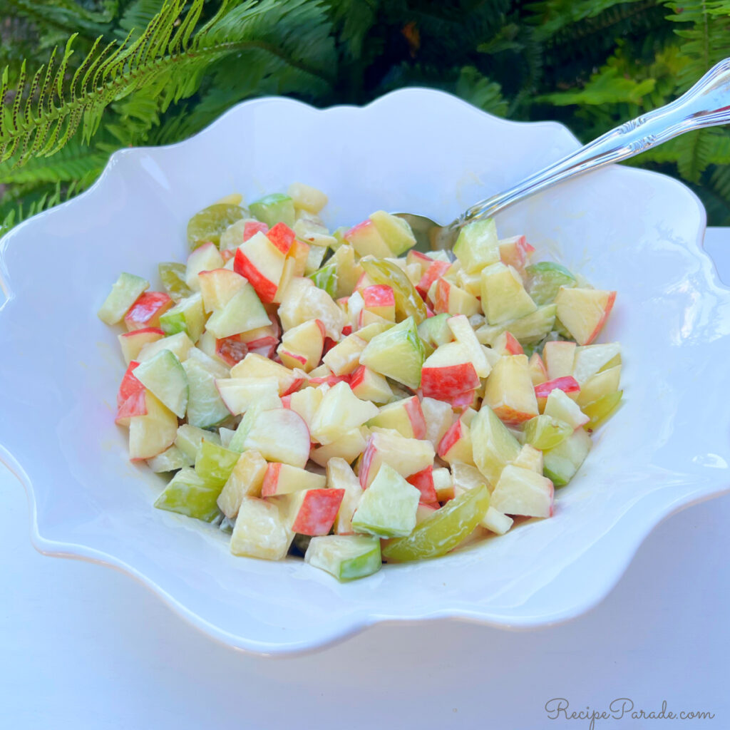 Apple salad in a white bowl.