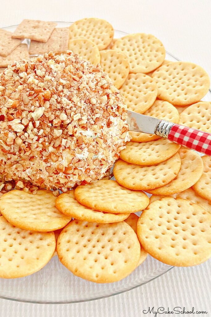 Pineapple cream cheese ball on a platter with crackers.