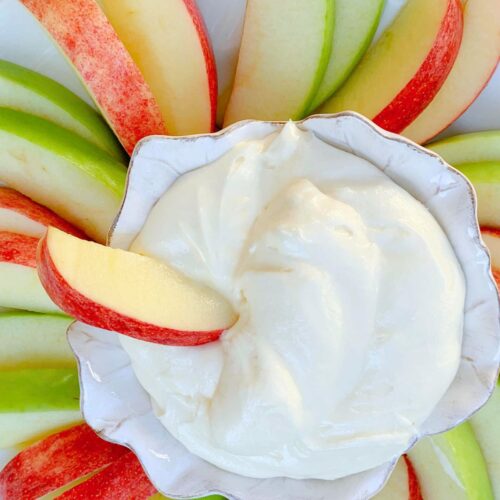 Platter of sliced apples with a bowl of apple dip.