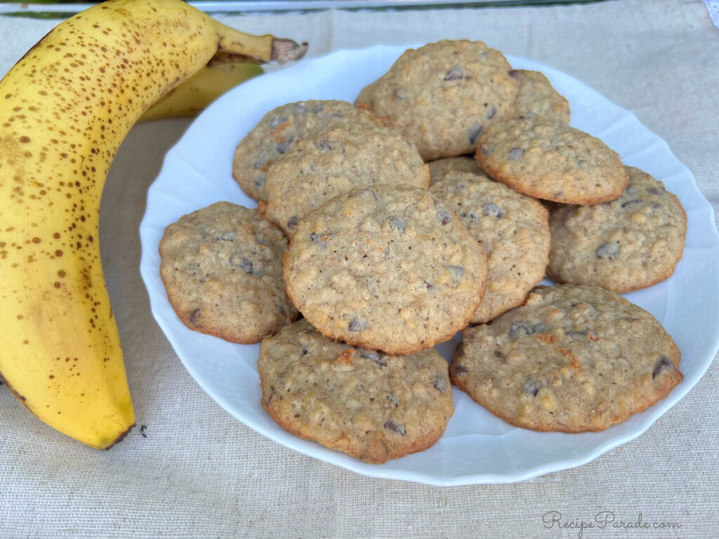 Plate of Banana Oatmeal Cookies, with a banana lying next to it.