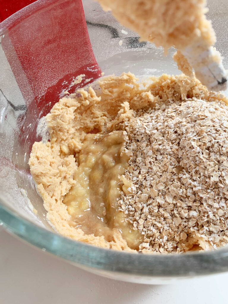 Mixing bowl with banana oatmeal cookie ingredients.