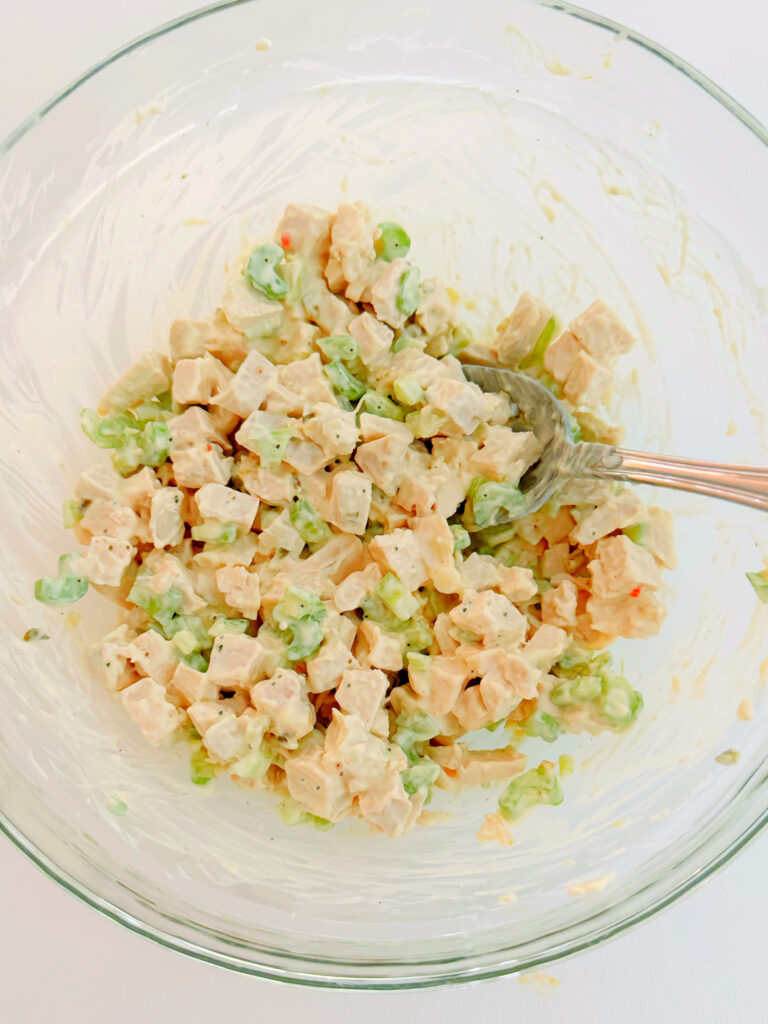 Combining Chicken Salad Ingredients in bowl.