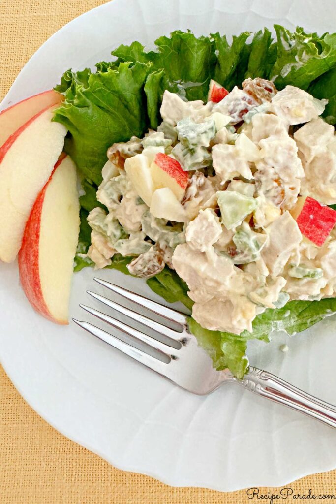 Scoop of classic chicken salad on a bed of lettuce.