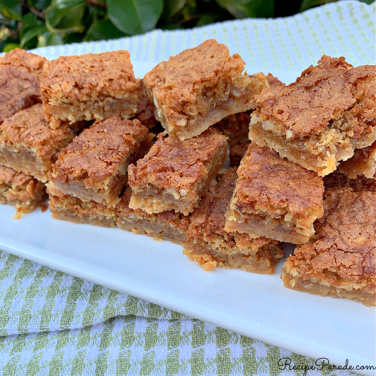 Dream bars arranged on a white platter.