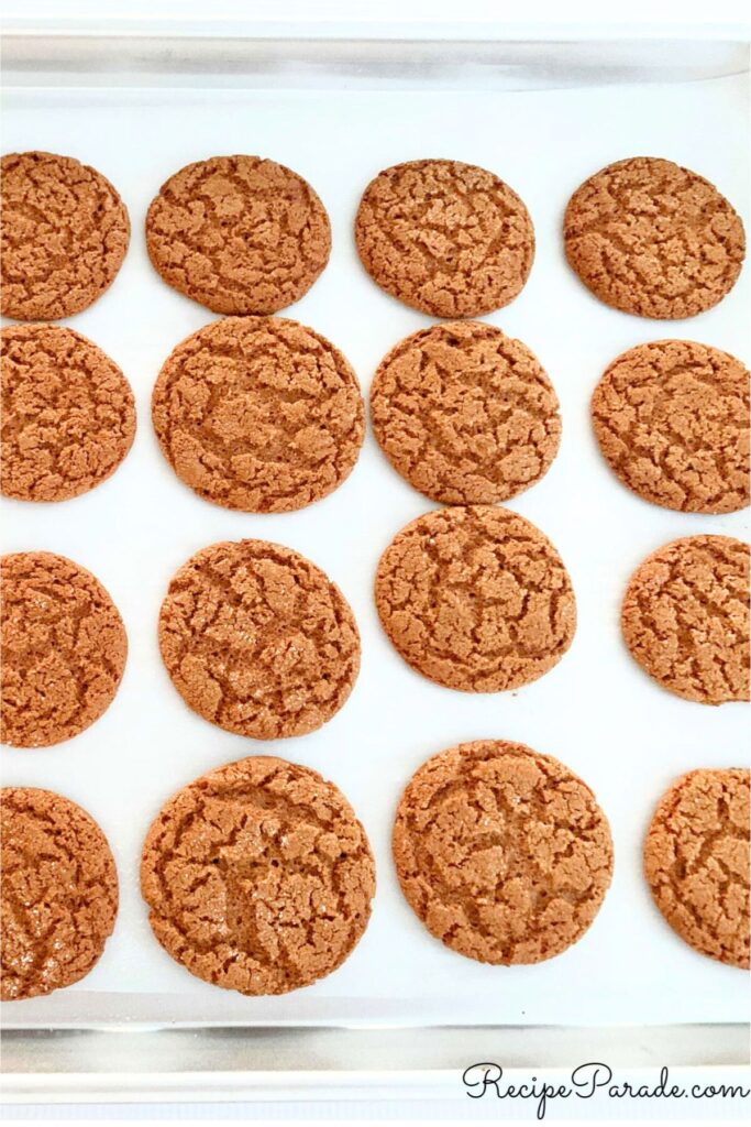 Freshly baked Ginger Snaps on a parchment lined cookie sheet.