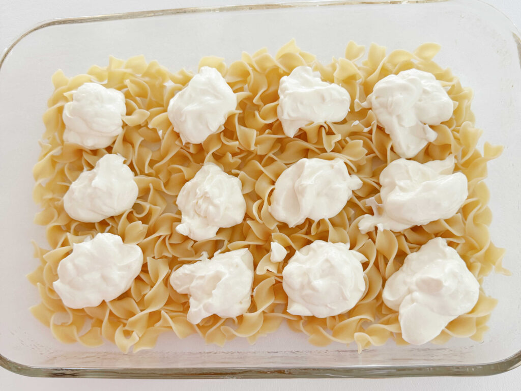 Dollops of the cream cheese mixture over the baked noodles.