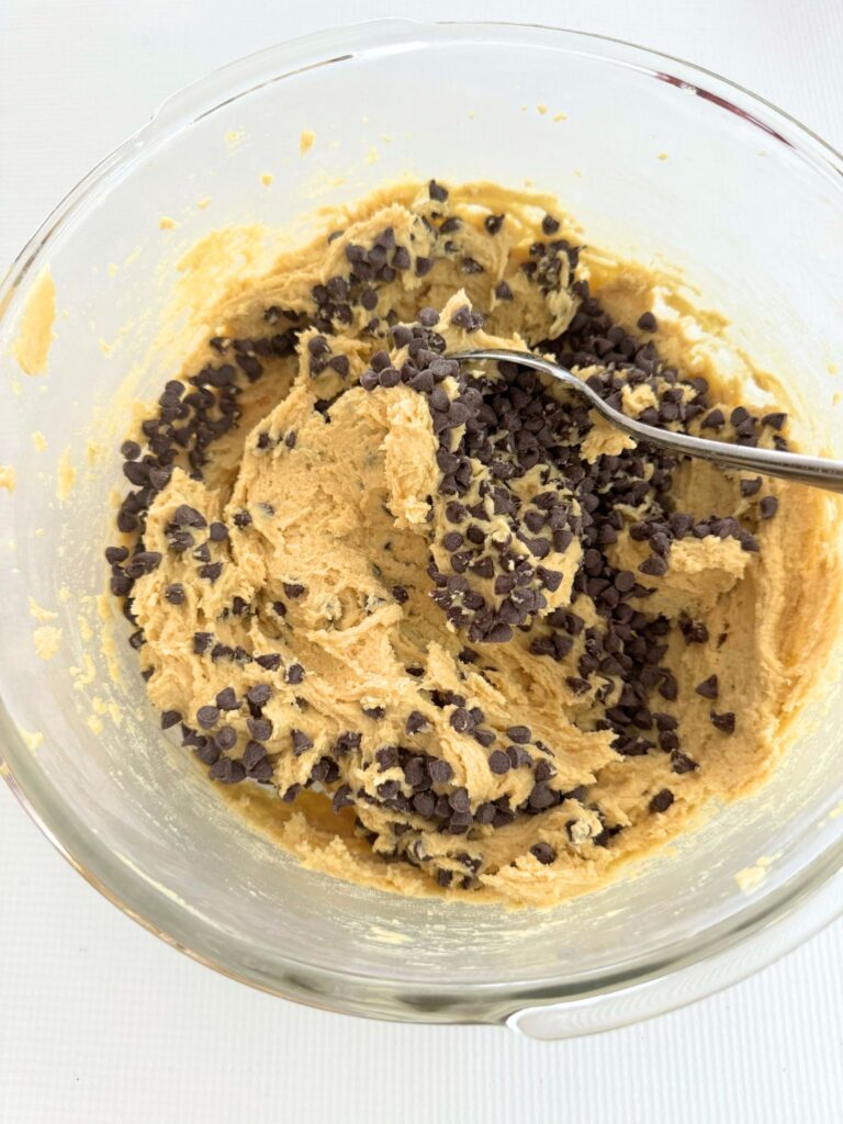 Folding chocolate chips into the cookie dough.
