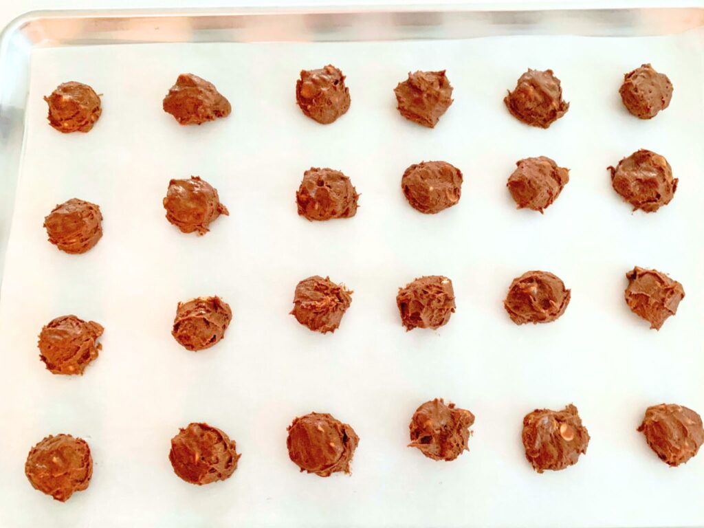 Chocolate Peanut Butter Cookie dough balls on cookie sheet.