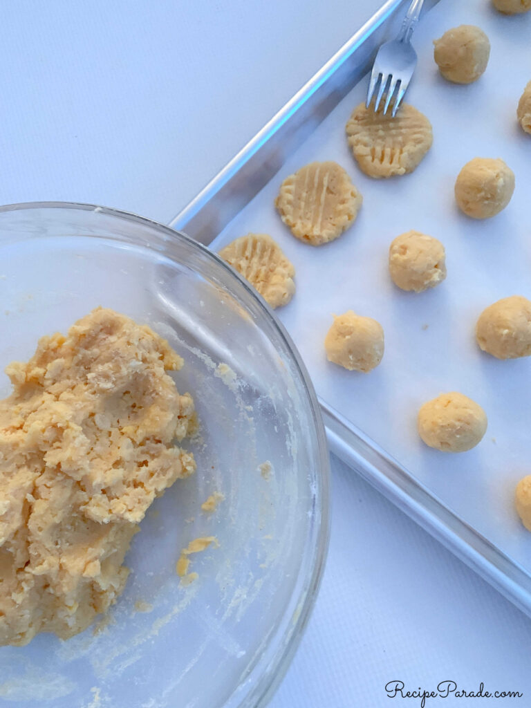 Placing dough onto cookie sheet for cheese wafers.