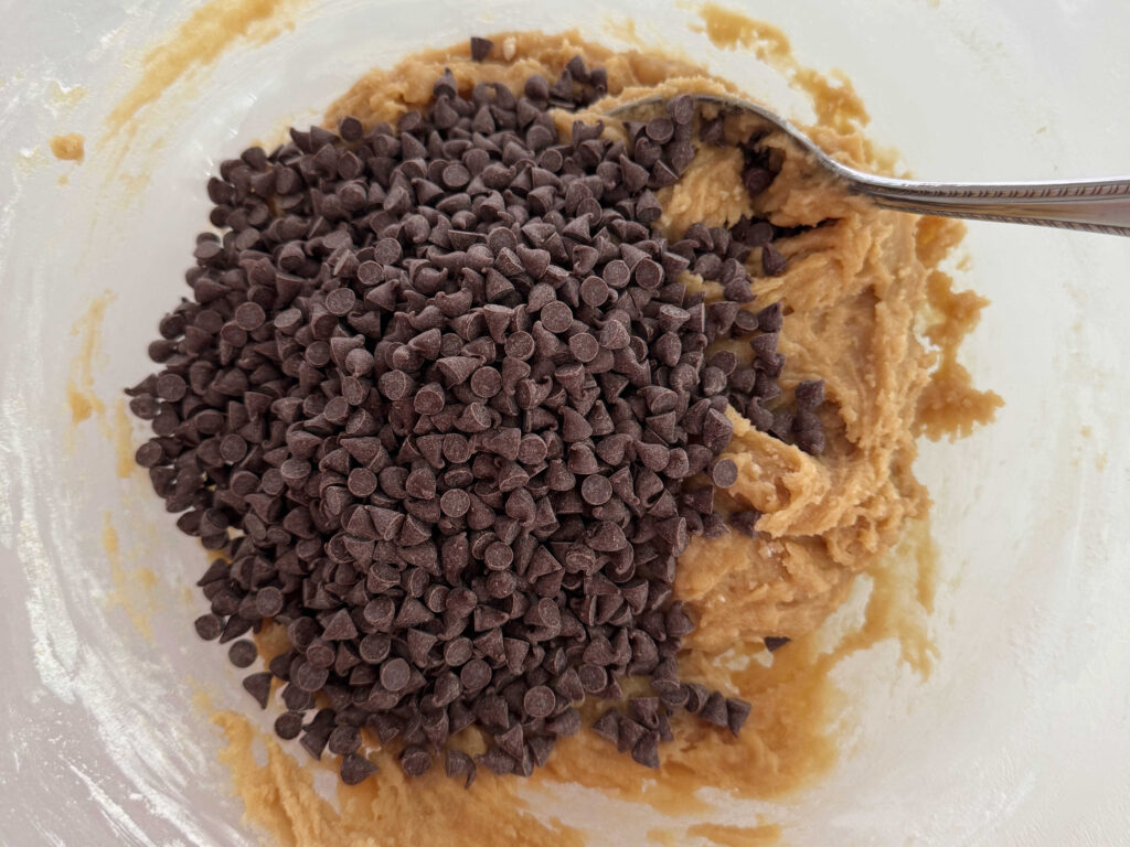 Mixing the chocolate chips into the cookie dough.