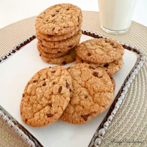Chewy Chocolate Chip cookies on a tray with milk.