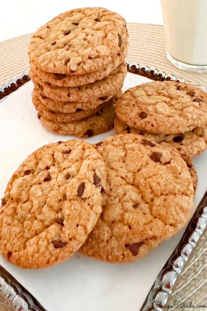 Chewy Chocolate Chip Cookies on a tray with milk.