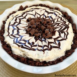 Mint Chocolate Ice Cream Pie, topped with chocolate syrup and chocolate curls.