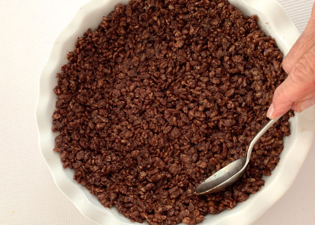 Making a chocolate Rice Krispies crust.