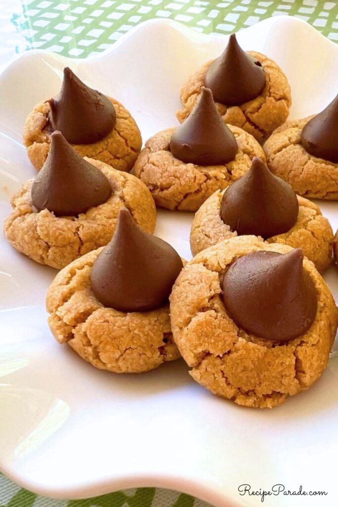 Gluten Free Peanut Butter Blossoms on a cake pedestal.