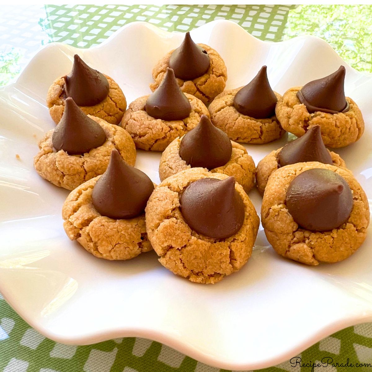 Gluten free Peanut Butter Blossom Cookies on a cake pedestal.
