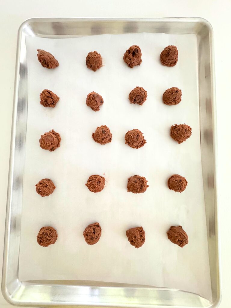 Balls of Chocolate Pudding Cookie Dough on pan.