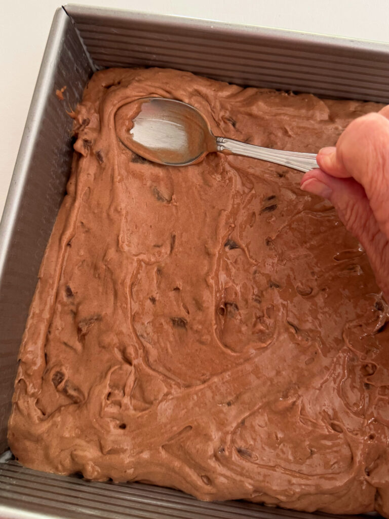 Spreading the pan with the easy chocolate apple cake batter.